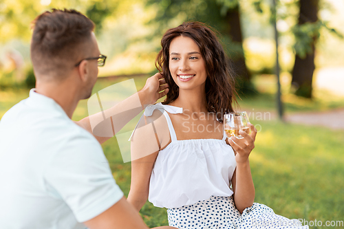 Image of happy couple having picnic at summer park