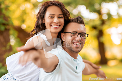 Image of happy couple having fun at summer park