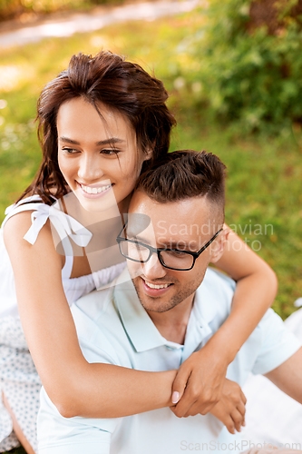 Image of happy couple hugging at summer park