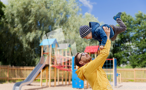 Image of father with son playing and having fun outdoors