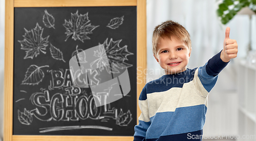 Image of little student boy showing thumbs up