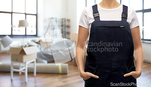 Image of close up of female worker in overall at new home