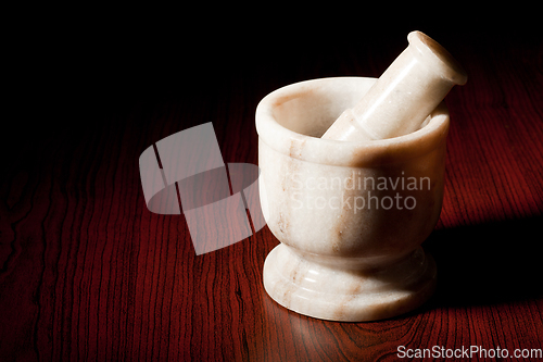 Image of Marble mortar and pestle on dark