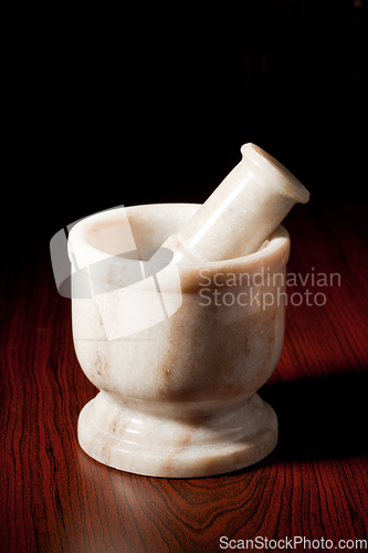 Image of Marble mortar and pestle on dark