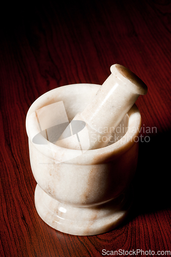 Image of Marble mortar and pestle on dark
