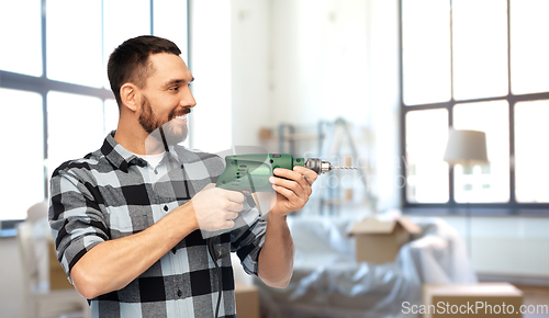 Image of happy man, worker or builder with drill at home