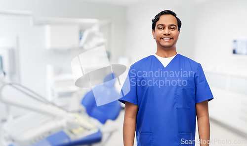 Image of happy indian doctor or dentist at dental office