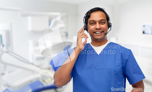 Image of indian doctor with headset at dental office