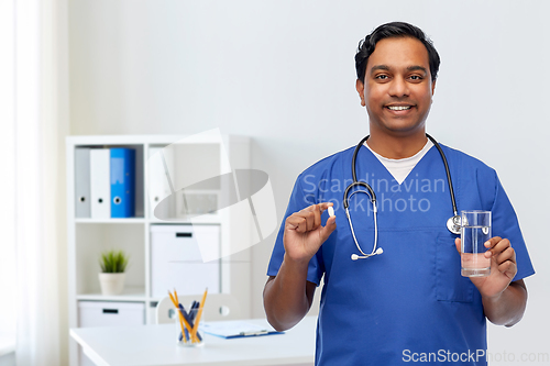 Image of indian doctor with medicine and glass of water