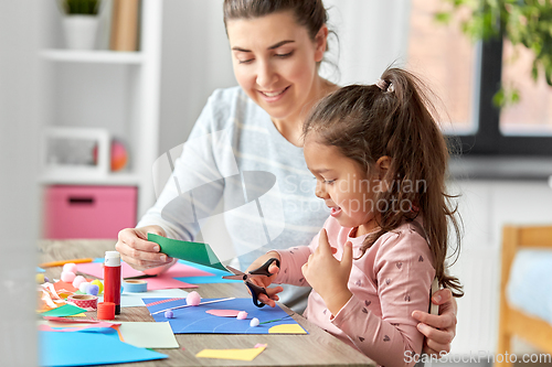 Image of daughter with mother making applique at home