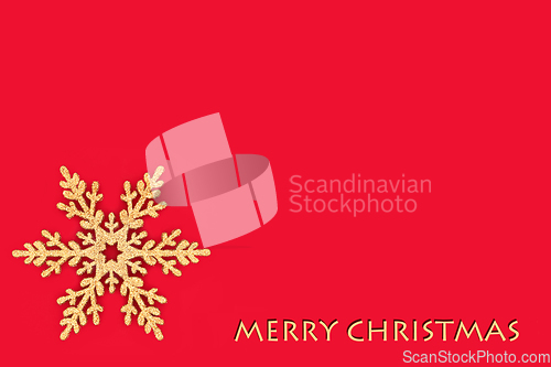 Image of Merry Christmas Gold Glitter Snowflake on Red Background