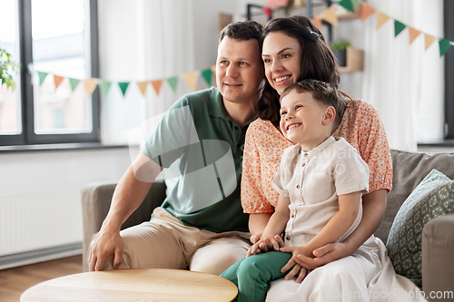 Image of happy family with little son at birthday party