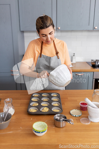 Image of woman cooking food and baking on kitchen at home