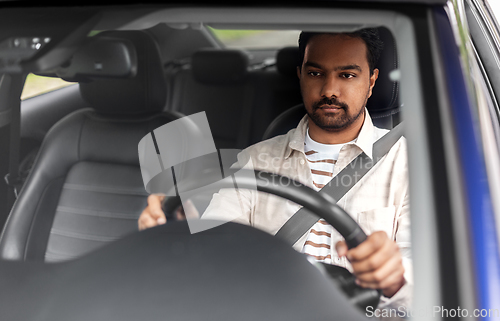 Image of indian man or driver driving car