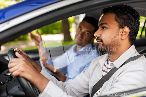 Image of car driving instructor talking to man failed exam