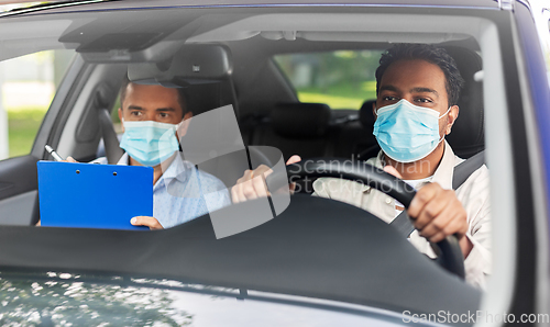 Image of car driving school instructor and driver in mask