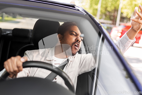 Image of angry indian man or driver driving car