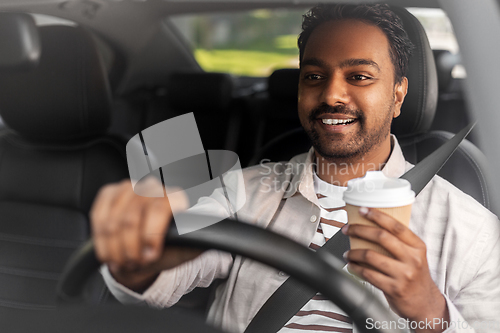 Image of happy indian man or driver with coffee driving car