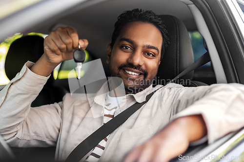 Image of smiling indian man or driver showing car key