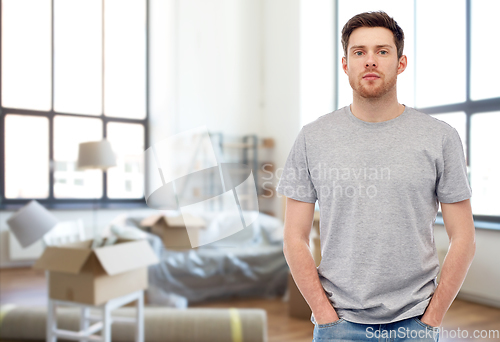 Image of young man in gray t-shirt at new home