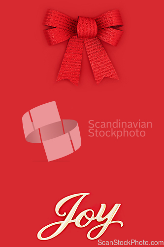 Image of Joy at Christmas and Festive Red Bow Background