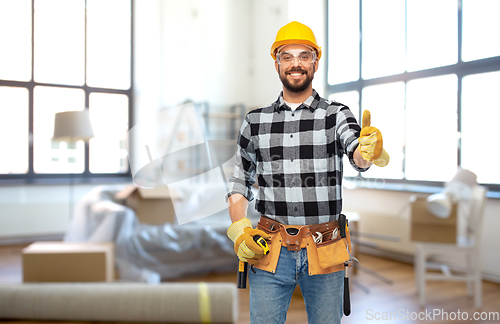 Image of happy male builder showing thumbs up at home