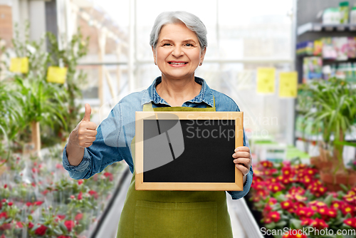 Image of senior gardener with chalkboard showing thumbs up