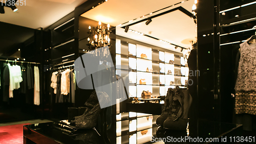 Image of bright and fashionable interior of shoe store in modern mall