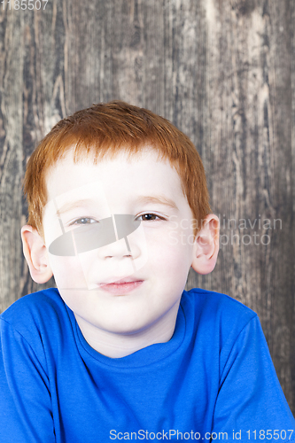 Image of cunning look of a red-haired boy