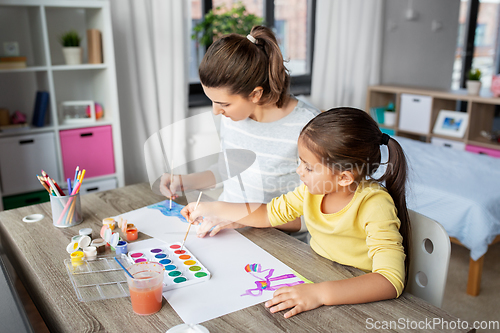 Image of mother with little daughter drawing at home