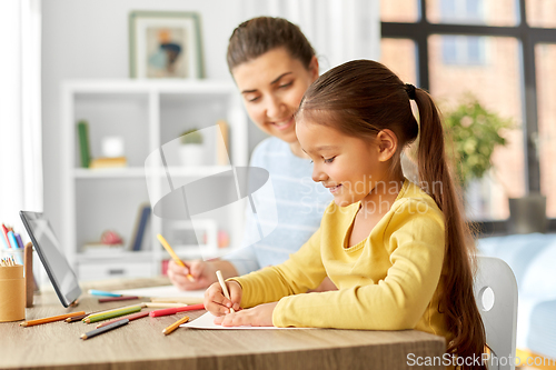 Image of mother with little daughter drawing at home