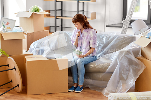 Image of asian woman moving to new home and counting money