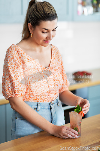 Image of woman making cocktail drinks at home kitchen