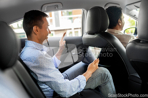 Image of man with tablet pc having video call in taxi car