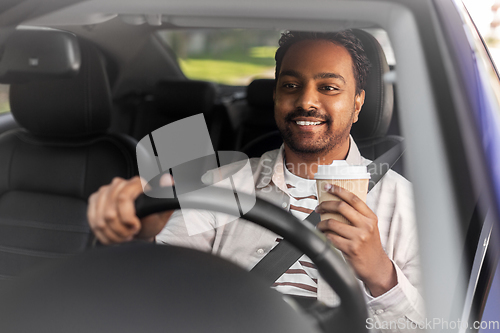 Image of happy indian man or driver with coffee driving car