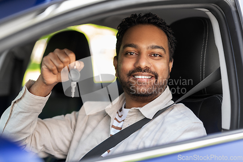 Image of smiling indian man or driver showing car key