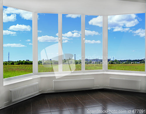 Image of window to the summer field and view of tubes of city