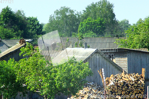 Image of Rural manor with house firewood and shed