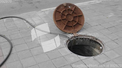 Image of Close up of metal cover over concrete manhole at construction site