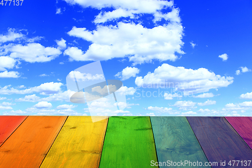 Image of multicolored stand from wooden boards and blue sky