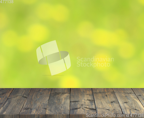 Image of stand from wooden boards with green blurred image