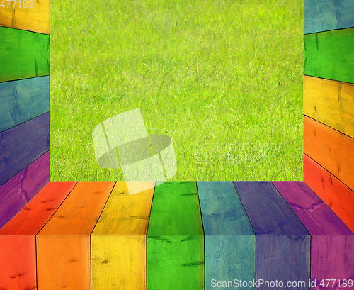 Image of table from multicolored wooden boards and grass