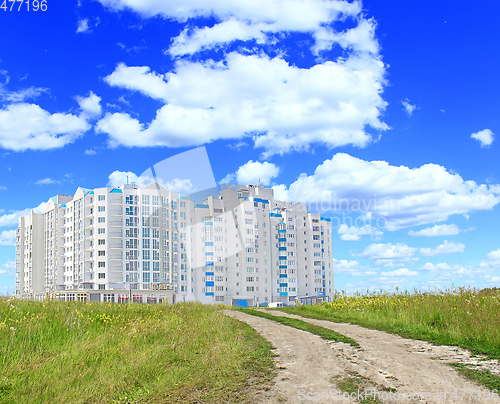 Image of multistory modern house in field with country road