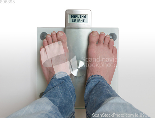 Image of Man\'s feet on weight scale - Healthy weight