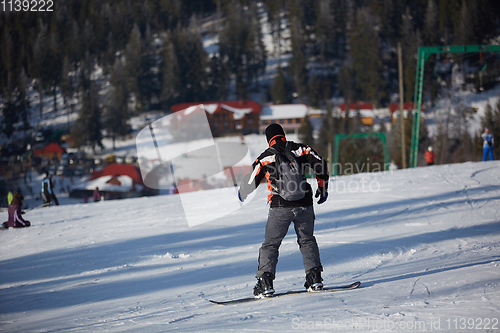 Image of Man snowboarder rides on the slope. ski resort. Space for text