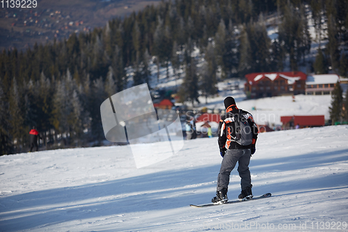 Image of Man snowboarder rides on the slope. ski resort. Space for text