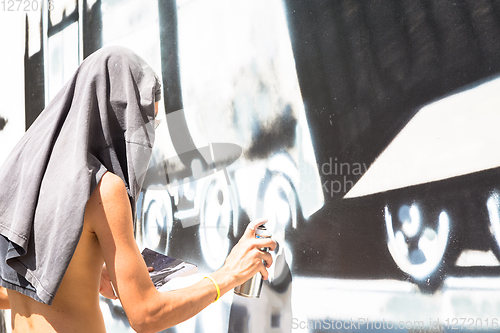 Image of Writer working on a wall in an anonymous way