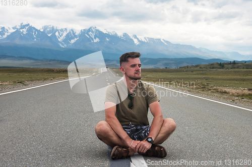 Image of Man sitting on the road