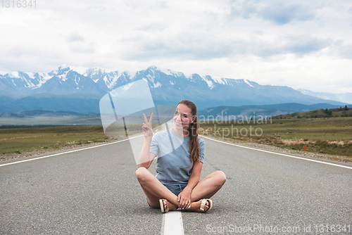 Image of Woman sitting on the road