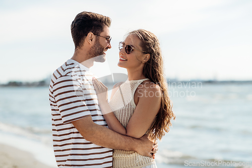 Image of happy couple on summer beach